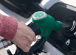 Persona che fa rifornimento di carburante con una pompa, simbolo dell’aumento dei prezzi e dell’impatto delle accise.