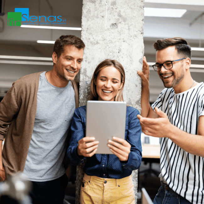 Locazione operativa piccoli canoni, grandi vantaggi per le aziende Tre giovani professionisti osservano un tablet in ufficio, immagine rappresentativa della locazione operativa e delle soluzioni tecnologiche per aziende.